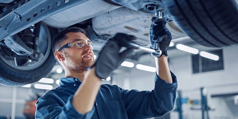 mechanic doing work on vehicle 