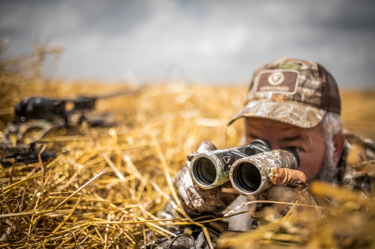 hunter looking through hunting binoculars