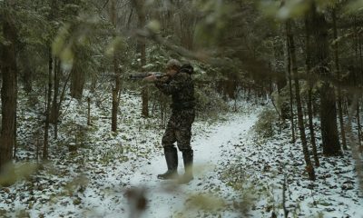 a person in the wild hunting with shotguns