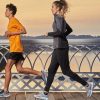 man and woman running wearing mizuno sportswear