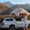 Truck with tent and two people in nature