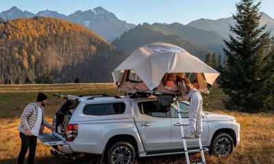 Truck with tent and two people in nature