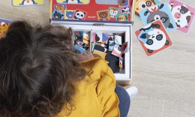 kid playing with magnetic toys on the floor