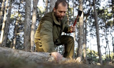 a person in the wilderness using a bushcraft axe